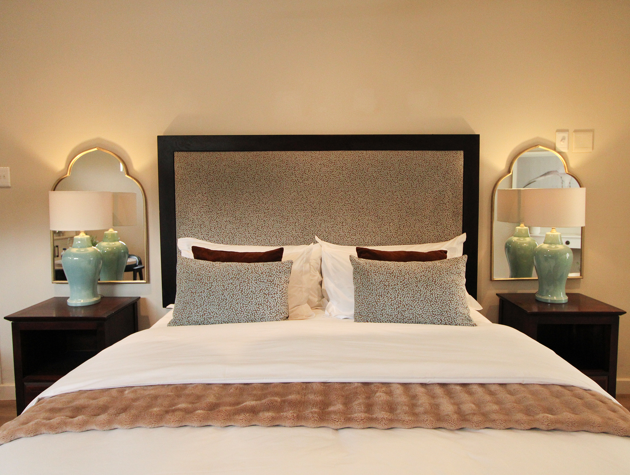 King bed with velvet headboard in The Master Suite at Oak Manor in Newlands